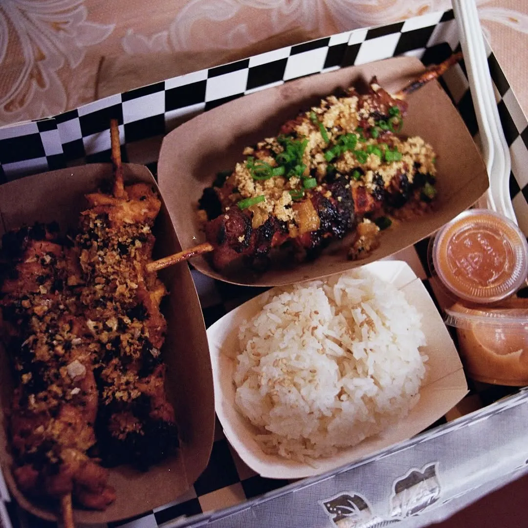 Skewers with rice in a checkered tray