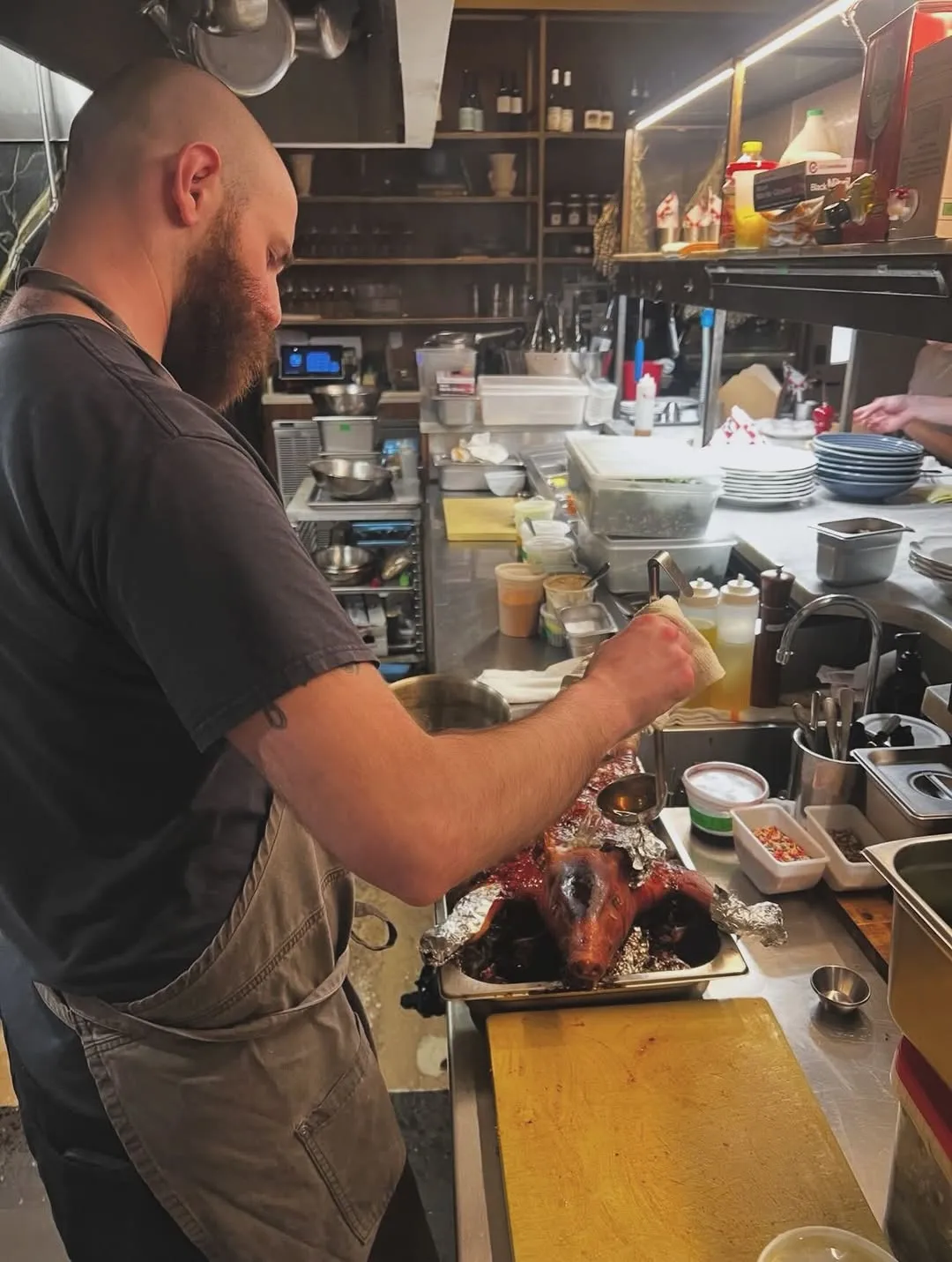 Harrison prepping lechon in the Kinsley kitchen
