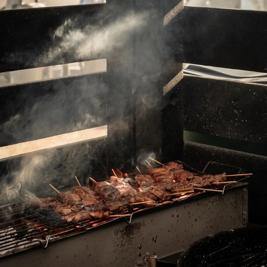 Skewers sizzling over open flame on the grill